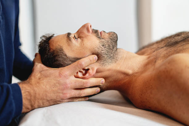 Driver holding a stiff, sore neck after a long road trip